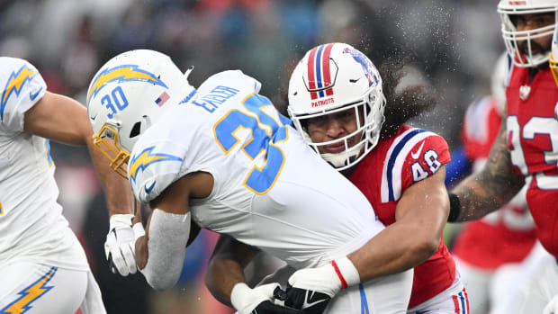 Dec 3, 2023; Foxborough, Massachusetts, USA; New England Patriots linebacker Jahlani Tavai (48) tackles Los Angeles Chargers running back Austin Ekeler (30) during the first half at Gillette Stadium. Mandatory Credit: Brian Fluharty-USA TODAY Sports